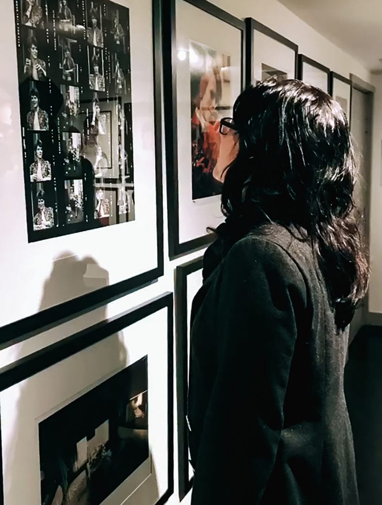 a woman looks at photographs on exhibit at the Morrison Hotel Gallery in Los Angeles