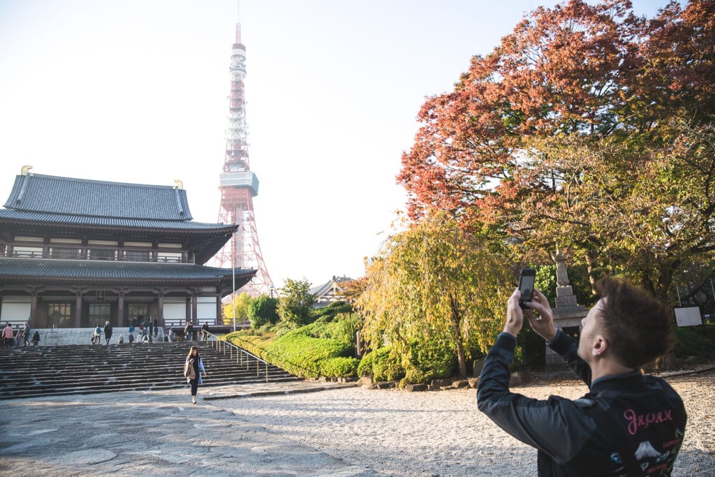 Stephen takes a photo of a shrine in Tokyo, Japan, with Tokyo Tower in the background