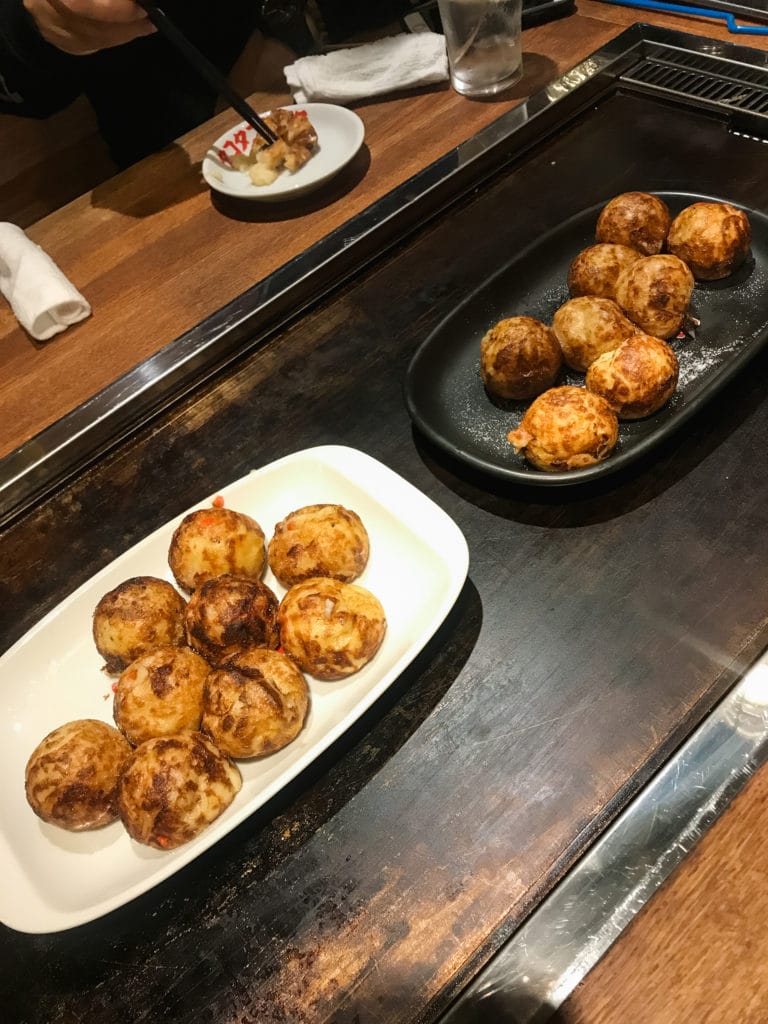 plates of takoyaki in a Japanese eatery